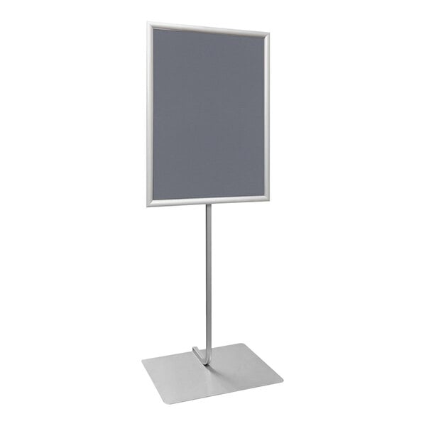 A white rectangular sign with a silver frame on a metal stand.