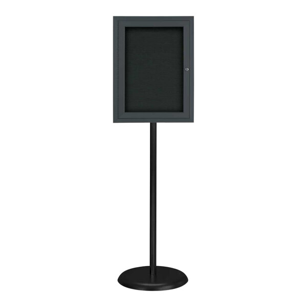 A black rectangular sign on a black stand.
