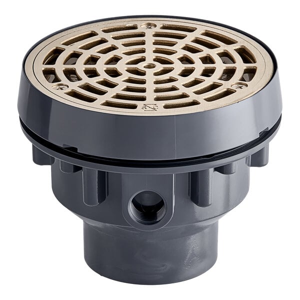 A Sioux Chief light-duty floor drain with a round nickel bronze strainer over a grey circular base.