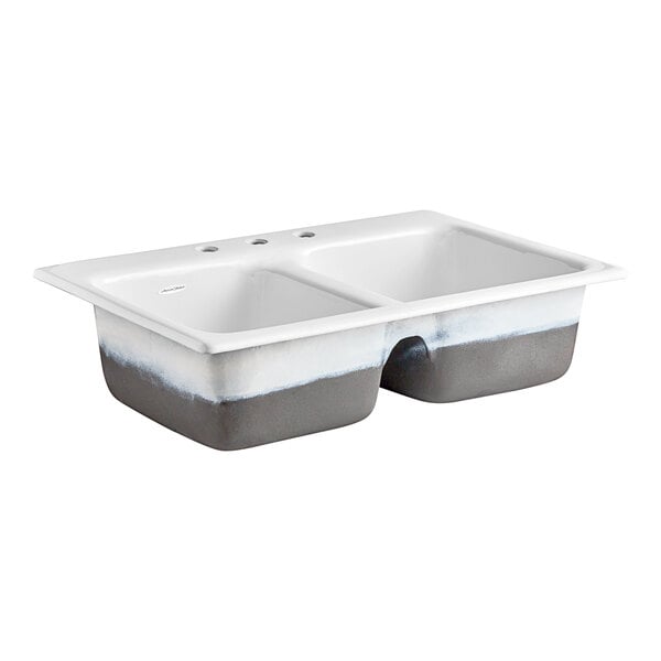 A white American Standard double sink with two holes.