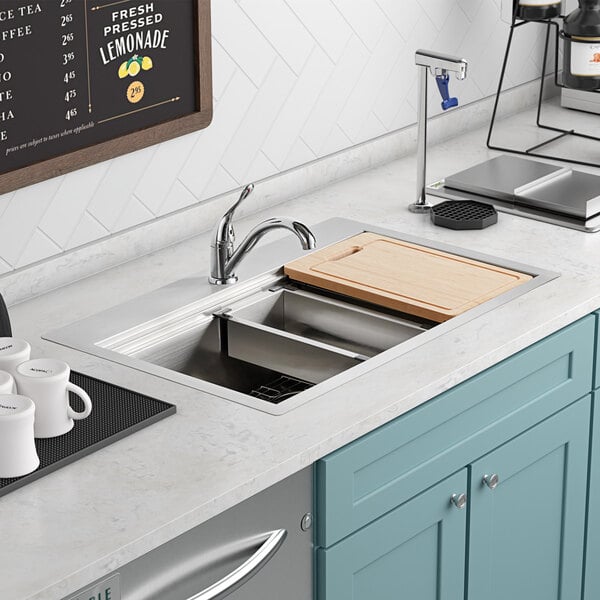 An American Standard Chive workstation sink installed in a kitchen counter.