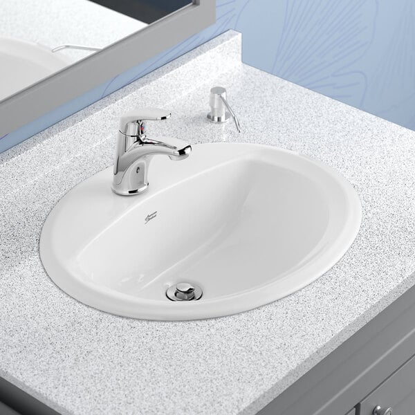A white American Standard drop-in sink with a center hole.