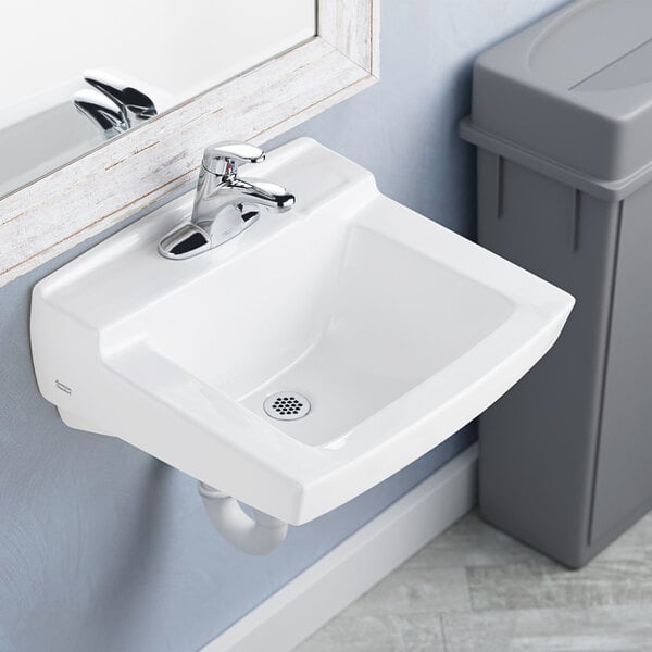A white American Standard Declyn wall-mount bathroom sink with silver faucet.