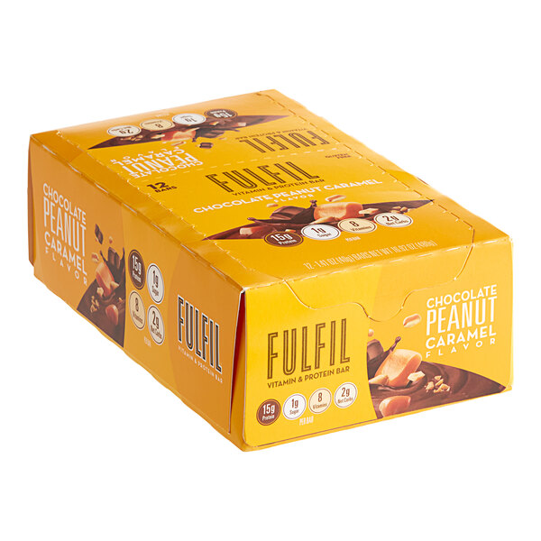 A yellow box of FULFIL Chocolate Peanut Caramel protein bars.