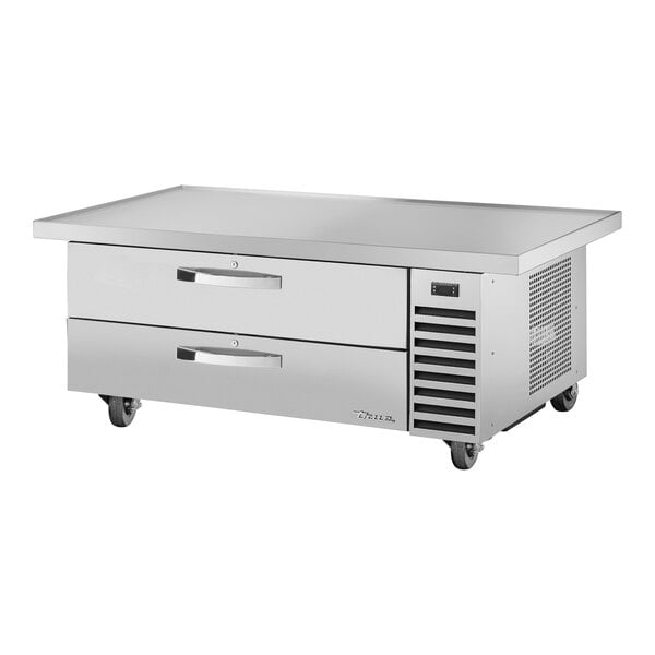 A stainless steel True refrigerated chef base with 2 drawers on wheels.