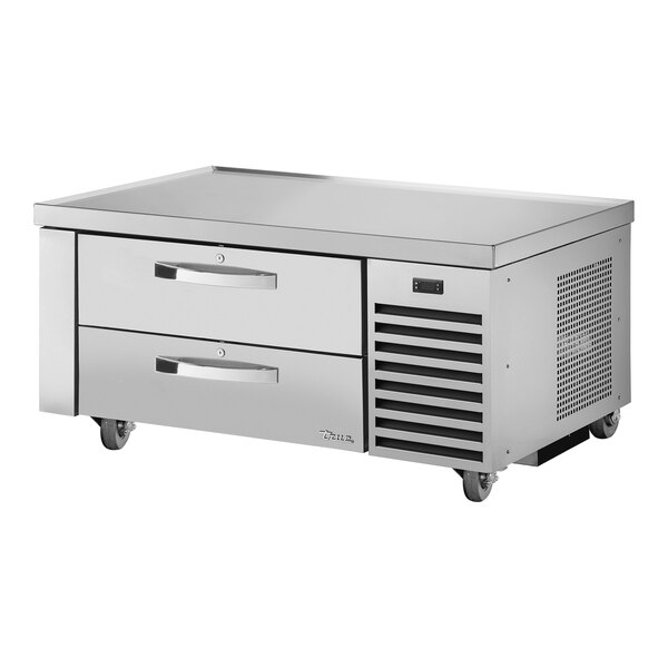 A stainless steel counter table with two refrigerated drawers.