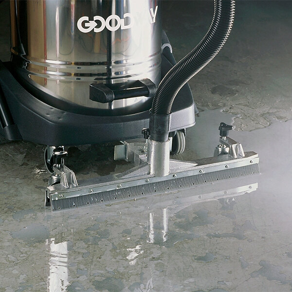 A Goodway Roll-Vac attachment with squeegee on a vacuum cleaner cleaning a wet floor.
