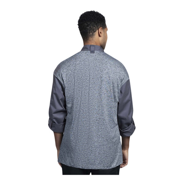 A man wearing an Uncommon Chef Roma long sleeve chef coat with a grey mesh back.