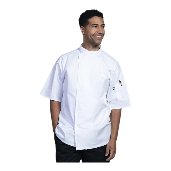 A man in a white Uncommon Chef Luca short sleeve chef coat with white mesh back.