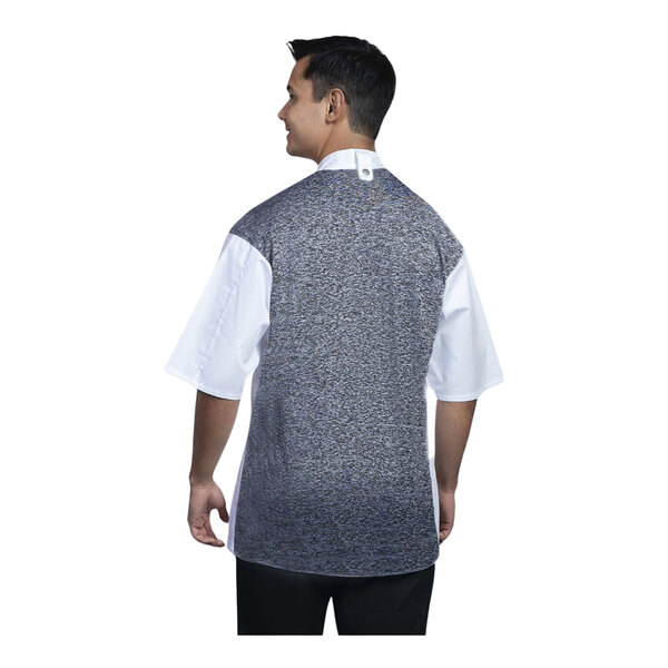 A man wearing a white Uncommon Chef Brac chef coat with black accents.