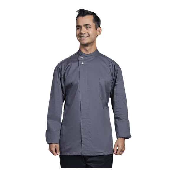 A man wearing a Uncommon Chef slate grey long sleeve chef coat with a grey mesh back.