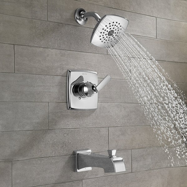 The Delta Ashlyn bath and shower trim kit with a chrome finish and monitor pressure balancing cartridge, including a close-up of a knob.