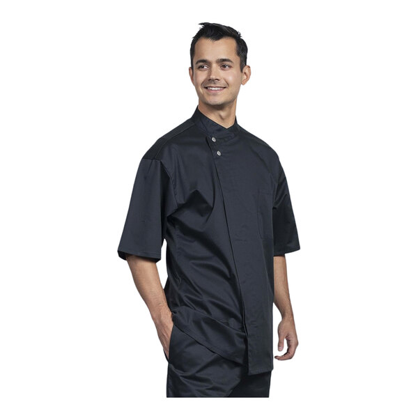 A man wearing a black Uncommon Chef Bari chef coat with black mesh.