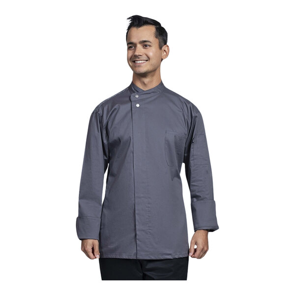 A man wearing a Uncommon Chef Solta grey long sleeve chef coat with a gray mesh back smiling.