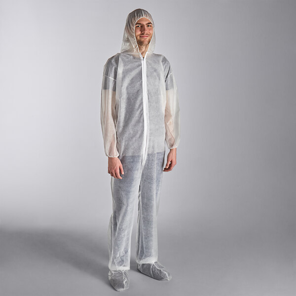A man wearing a white Lavex coverall with attached boots and hood.