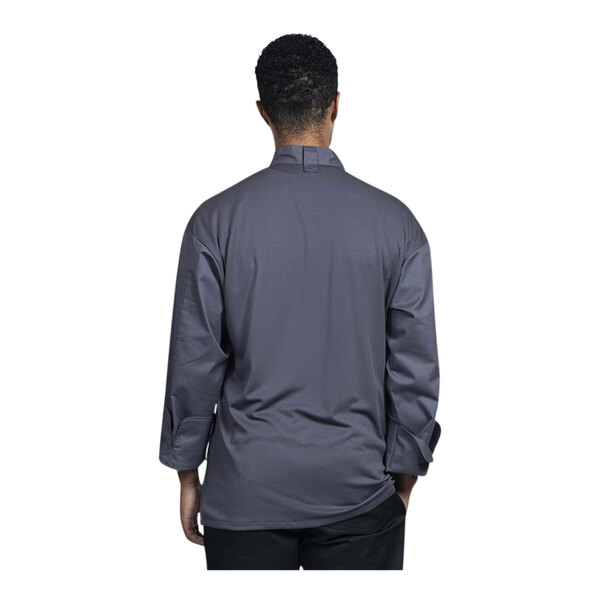 A man wearing an Uncommon Chef long sleeve chef coat with a slate mesh back.