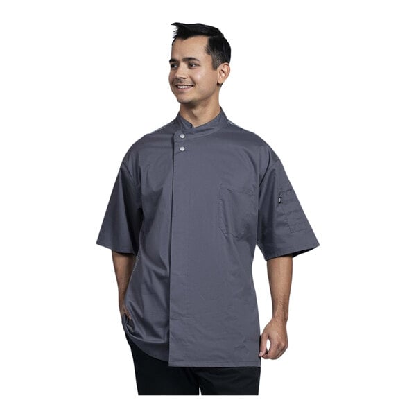 A man wearing a Uncommon Chef slate short sleeve chef coat with a grey mesh back.