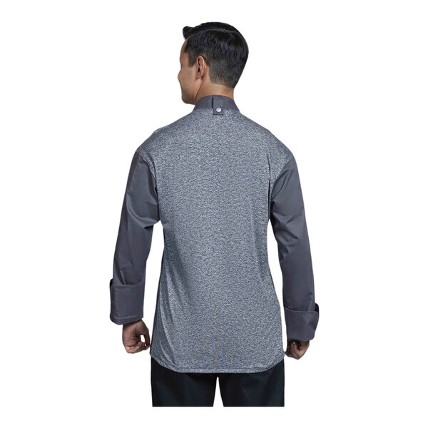 A man wearing a Uncommon Chef long sleeved chef coat with a grey mesh back.