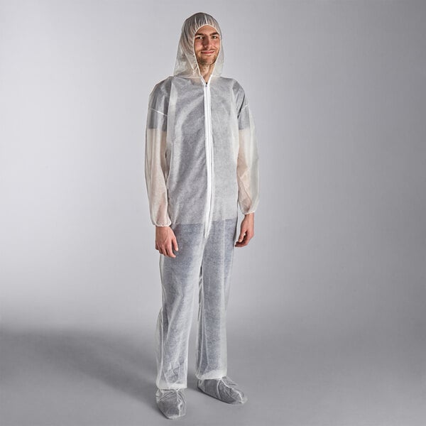 A man wearing a white Lavex coverall with attached boots and hood.