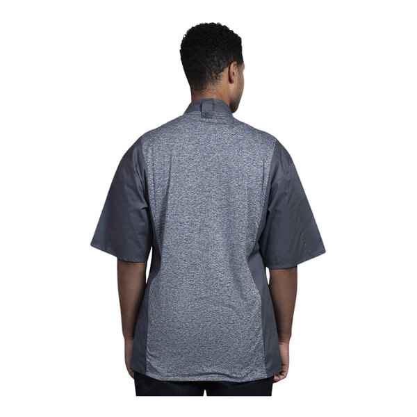 A man wearing a Uncommon Chef Florence slate chef coat with a grey mesh back.