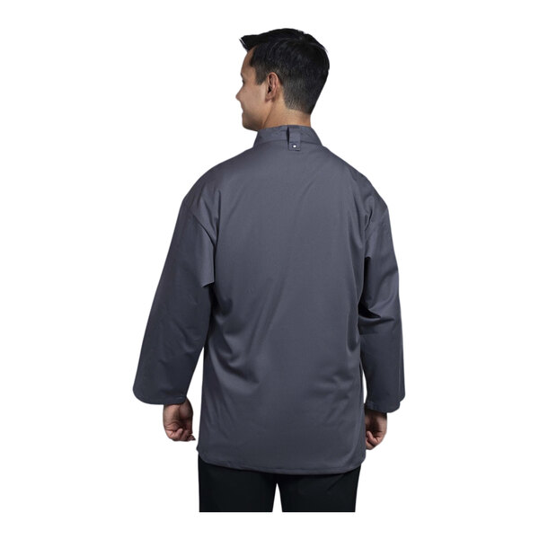 A man wearing a Uncommon Chef slate grey chef coat with slate mesh on the back.