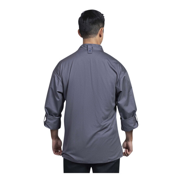 A man wearing an Uncommon Chef long sleeve chef coat with a slate mesh back.