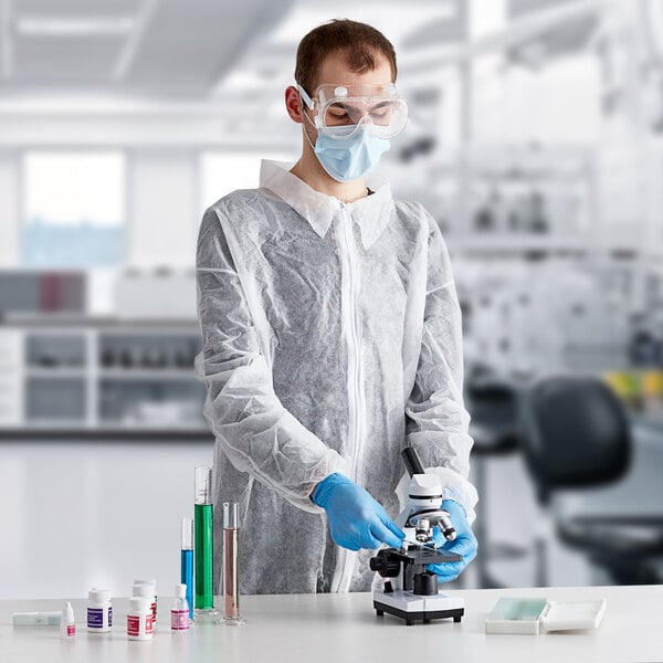 A person wearing Lavex white coveralls, a mask, and gloves.