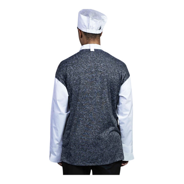 A person wearing a white Uncommon Chef Capri chef coat with a black mesh back.
