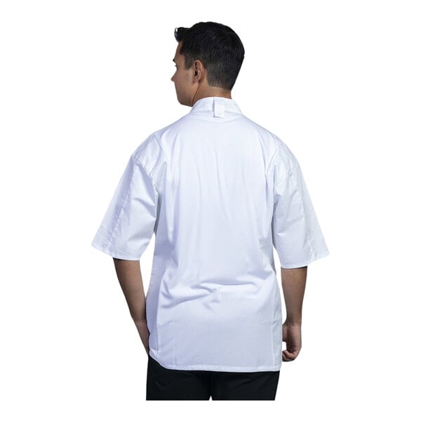 A man wearing an Uncommon Chef white short sleeve chef coat with white mesh back.