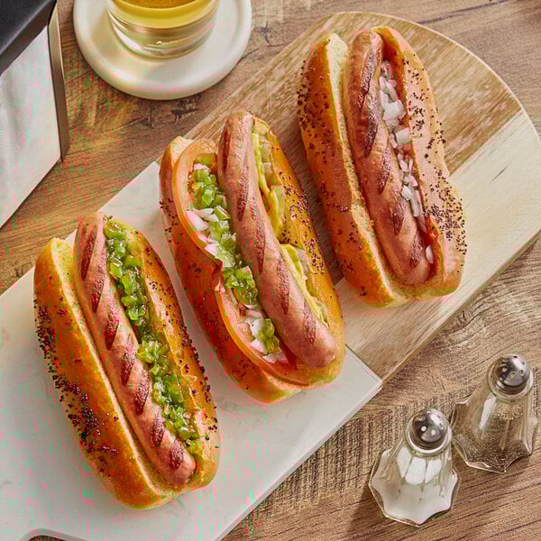 Three Vienna Beef natural casing beef franks on a white plate.