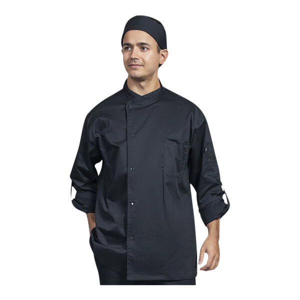 A man wearing a black Uncommon Chef Pisa chef coat with a black hat.