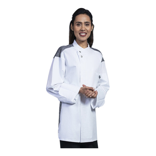 A woman wearing a white Uncommon Chef Solta chef coat with black mesh.
