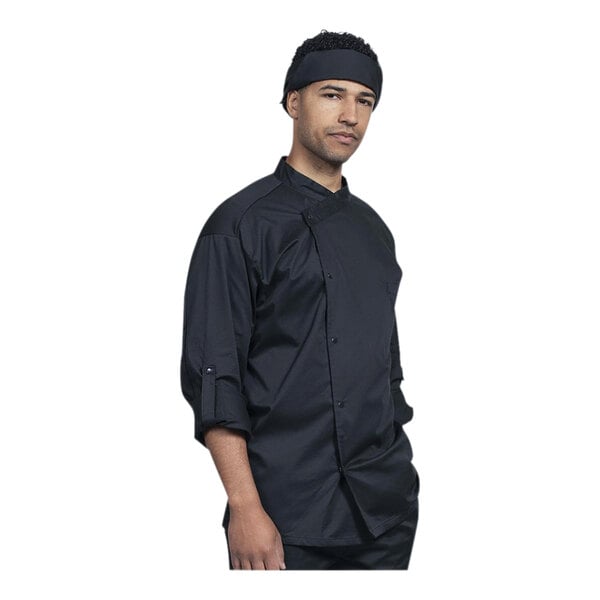 A man wearing a Uncommon Chef black chef coat with a black mesh back.