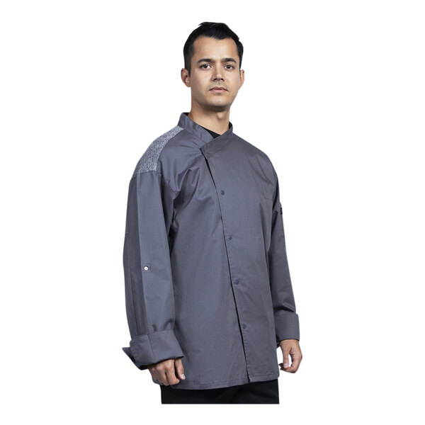 A man wearing a slate grey Uncommon Chef Capri chef coat with a mesh back.