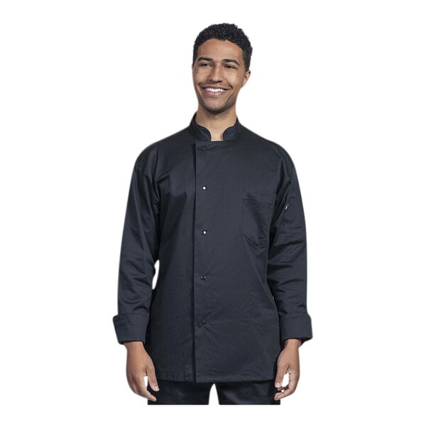 A man wearing a black Uncommon Chef long sleeve chef coat with a black mesh back smiling.