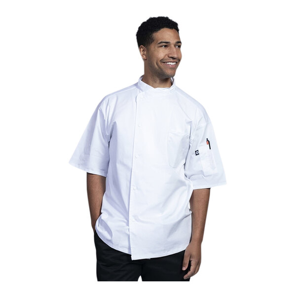 A man in a white Uncommon Chef Luca short sleeve chef coat with a white mesh back smiling.