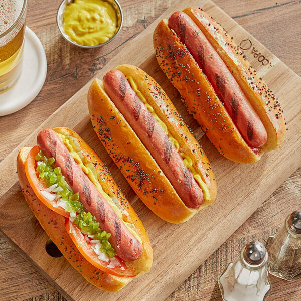 Vienna Beef hot dogs with mustard and ketchup on a wooden cutting board.