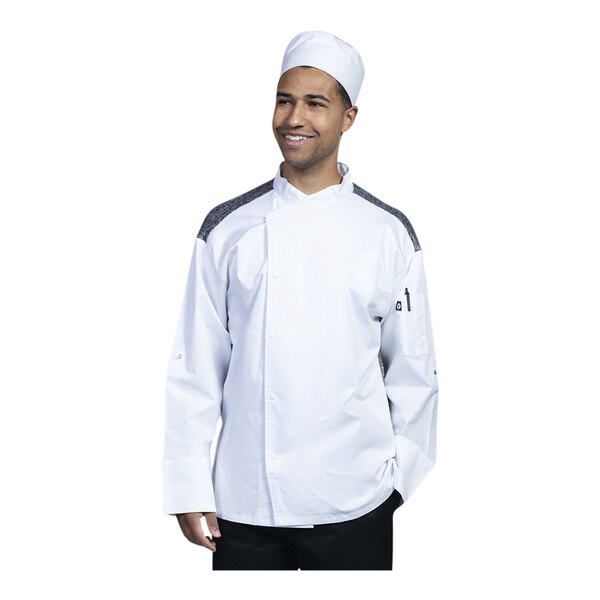 A man wearing a Uncommon Chef white chef coat and hat.