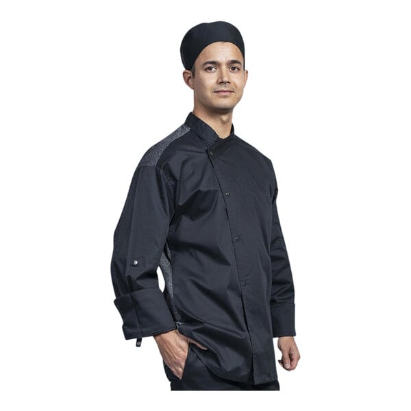 A man wearing a black Uncommon Chef Capri Chef Coat with silver mesh.