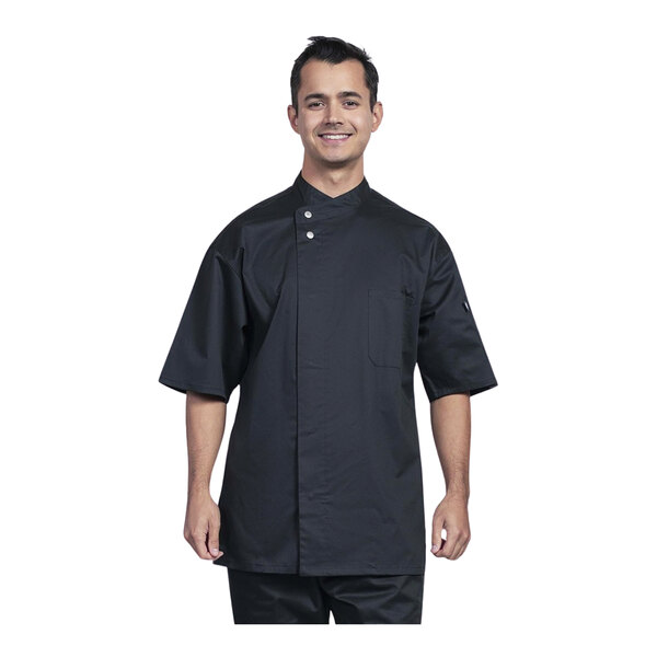 A man wearing a black Uncommon Chef Bari chef coat with black mesh.