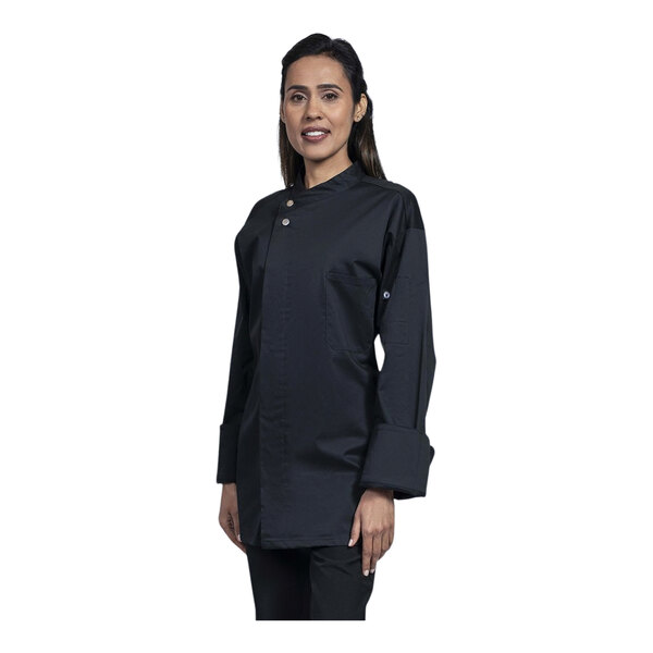 A woman wearing a black Uncommon Chef long sleeve chef coat with a black mesh back.