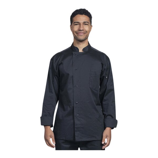 A man wearing a black Uncommon Chef long sleeve chef coat with a silver mesh back smiling.