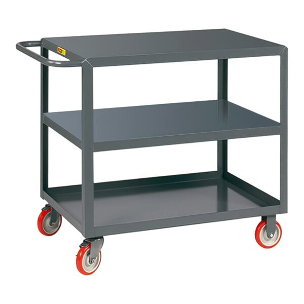 A Little Giant grey steel service cart with three shelves and polyurethane wheels with brakes.