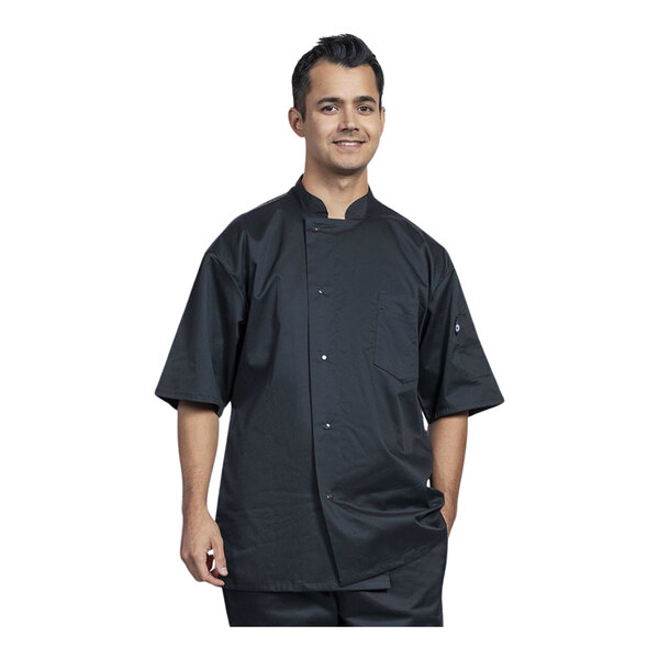 A man wearing a black Uncommon Chef short sleeve chef coat with silver mesh details.