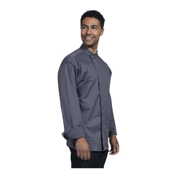 A man wearing a Uncommon Chef slate grey chef coat with a mesh back.