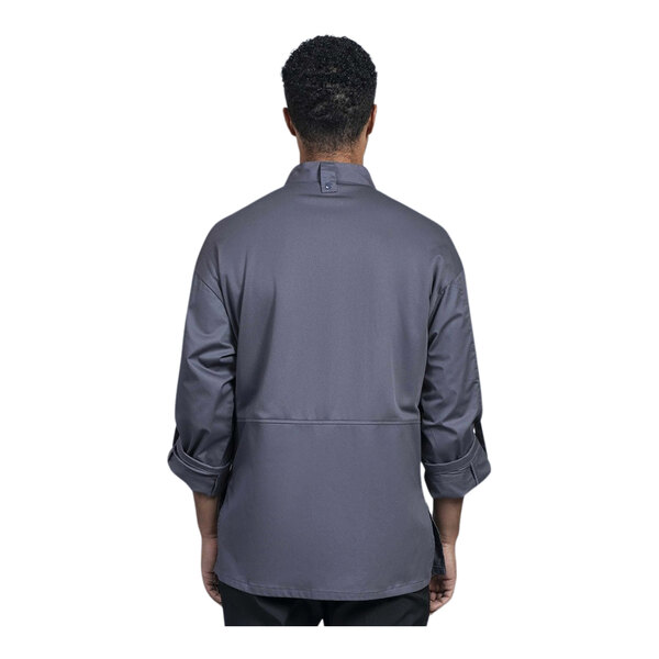 A man wearing a Uncommon Chef slate grey long sleeve chef coat with a slate grey half mesh back.
