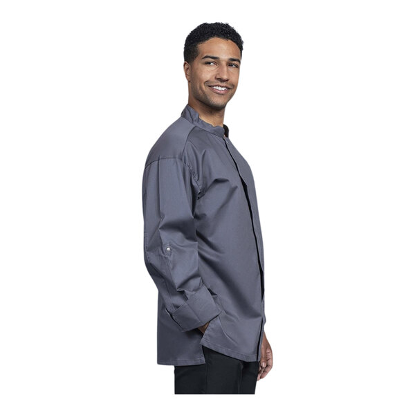A man wearing a Uncommon Chef Pescara Slate Convertible Long Sleeve Chef Coat with Slate Half Mesh Back.