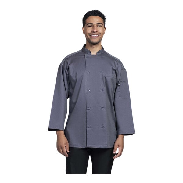 A man wearing an Uncommon Chef slate gray chef coat with gray mesh back.