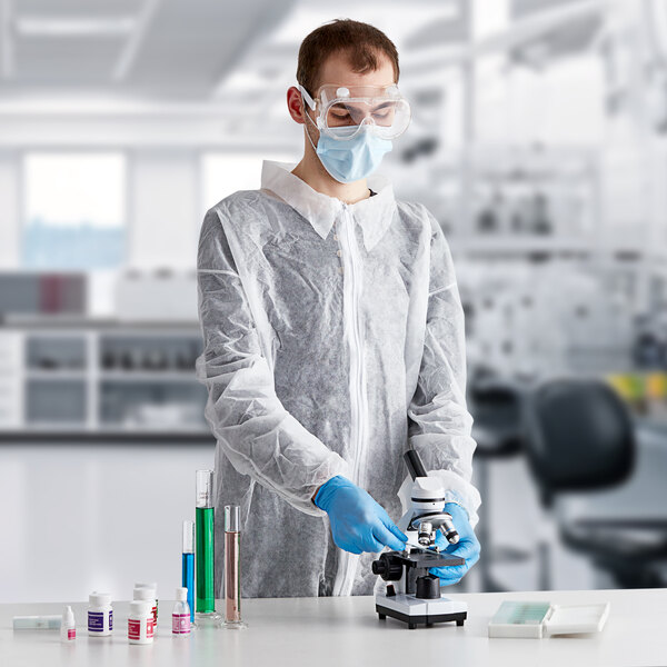 A man wearing Lavex white coveralls, a face mask, and gloves.