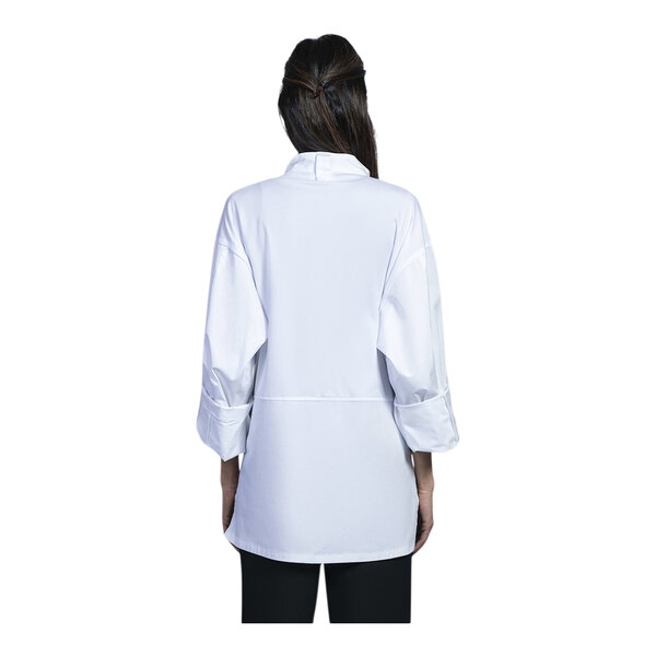 A woman wearing a white Uncommon Chef long sleeve chef coat.